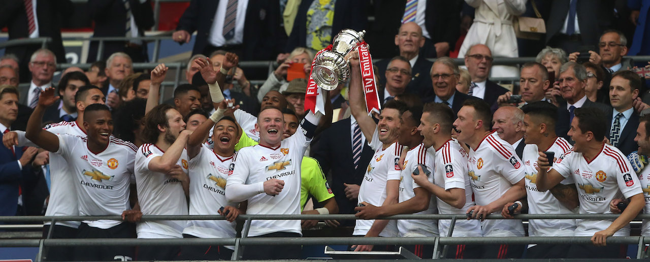 Manchester United team holds trophy